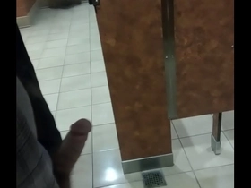 Jerking thick cock in public bathroom